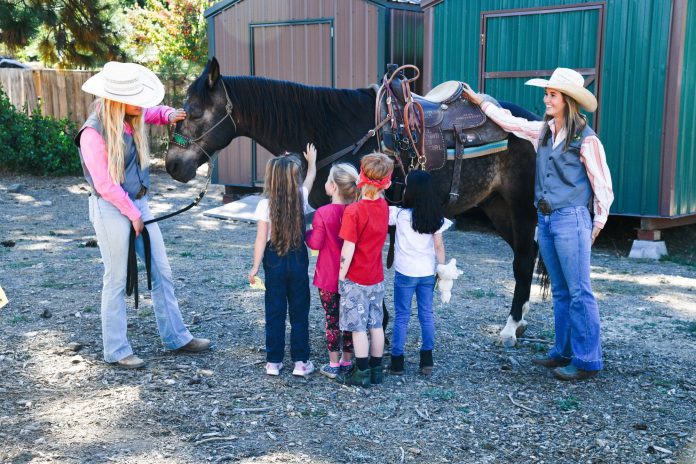 Students in Inge Stock's kindergarten class get an introduction to rodeo horse Rocket. Photos by Lisa Kelly and Clara Pokirski