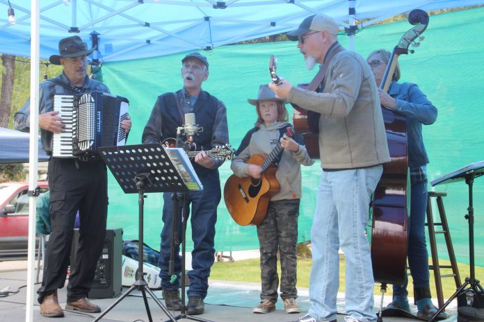 Quincy band The Candy Pickers plays at the Plumas Homegrown Americana Festival. From left: Lance Barker on accordion; Gary Broeder on mandolin; Lucius Kitchens, age 11, on guitar; Dean Oertle on guitar; and Jenn Kimble on bass. Photos by Ingrid Burke