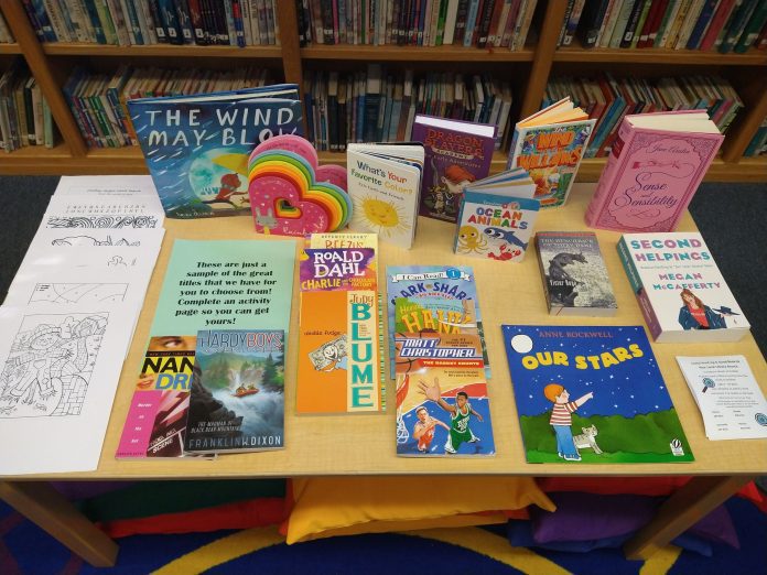 At the Chester library, families are invited to participate in the Project Read giveaway by completing an activity sheet and choosing a free book. Photo by Lori Metcalf