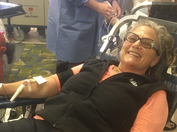 Susie Pettengill, Eastern Plumas Health Care Auxiliary vice president, smiles as she makes her blood donation at a past event. Photo courtesy Eastern Plumas Health Care Auxiliary
