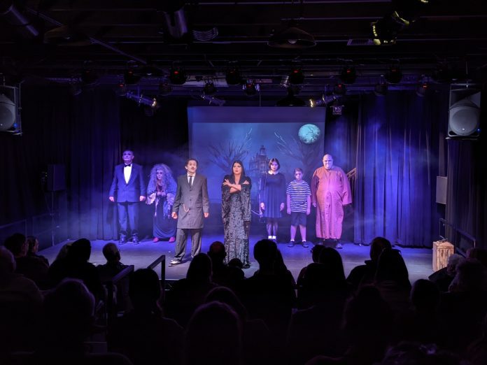 The Addams family is introduced. From left: Will Taylor as Lurch, Cheryl Nicoles as Grandma, David Riley as Gomez, Michelle Pfingston as Morticia, Nell Bejlde as Wednesday, Will Felker as Pugsley, and Pat Parks as Fester. Photo by Ingrid Burke