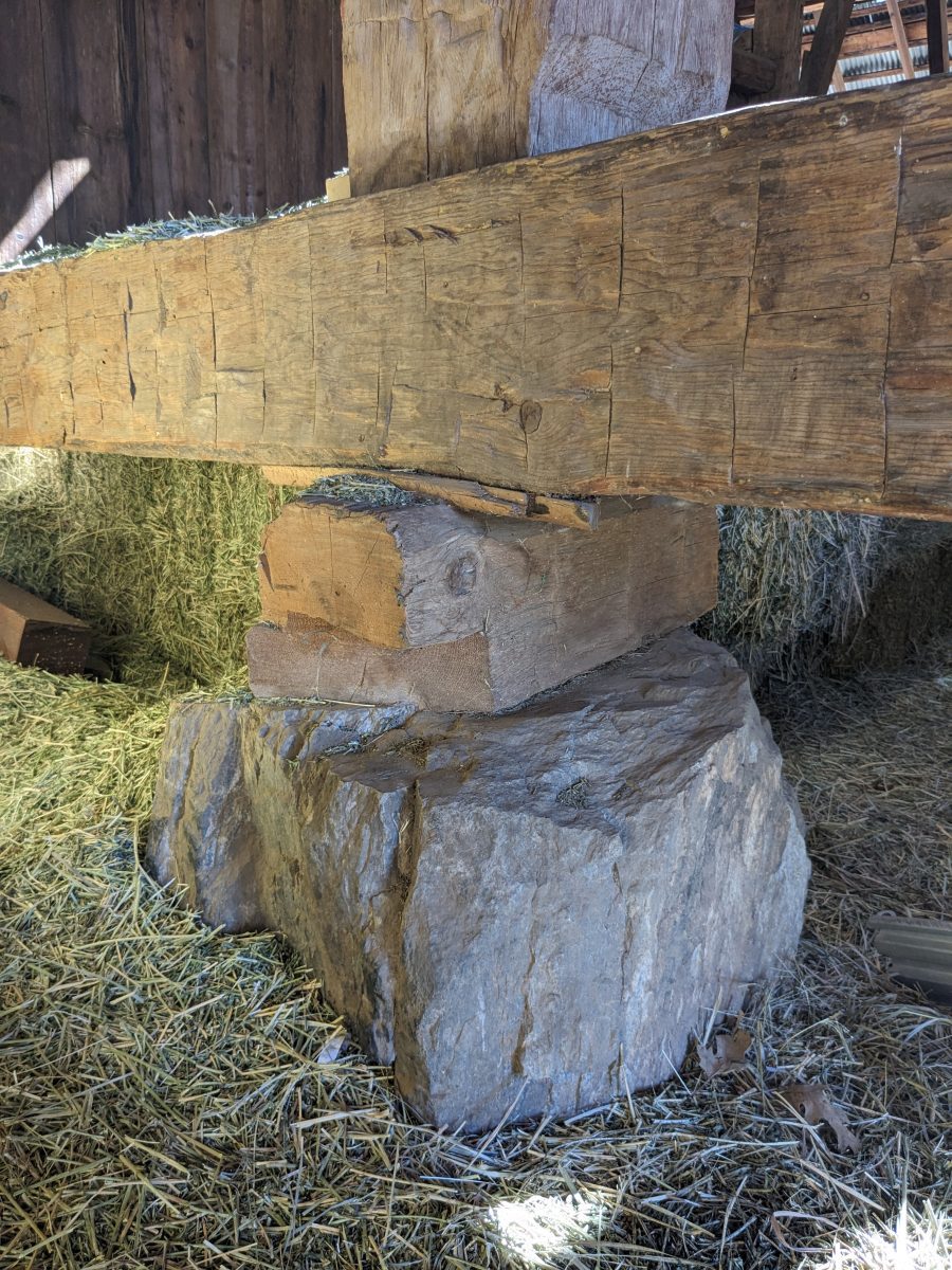 Stone and wood blocks support a handhewn mudsill in the barn at Chandler Ranch in American Valley