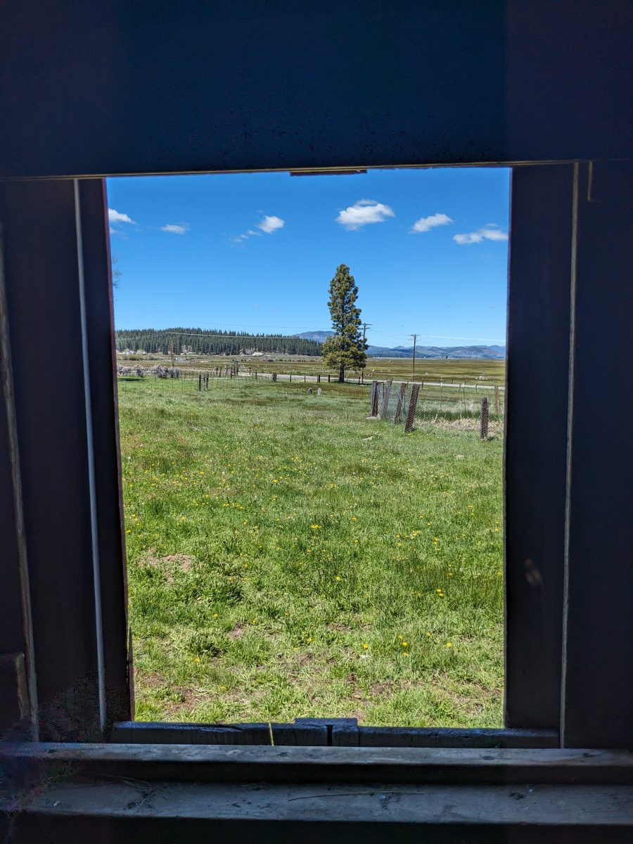 A sliding wooden window used to dispose of waste in the Strang barn in Sierra Valley